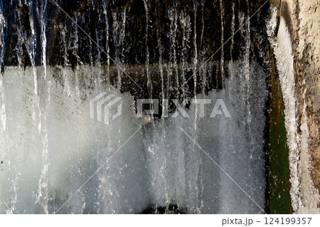 Water jets of a waterfall nearby. Waterfall in winter Water jets of a waterfall nearby. Waterfall in winter 124199357