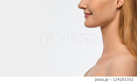 Side view cropped close-up image focusing on female lower face, delicate smile, smooth lips with natural gloss, flawless skin texture Side view cropped close-up image focusing on female lower face, delicate smile, smooth lips with natural gloss, flawless skin texture 124201352