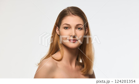 Charming woman with radiant skin and delicate smile, natural makeup, smooth hair cascading over shoulder, looking into camera Charming woman with radiant skin and delicate smile, natural makeup, smooth hair cascading over shoulder, looking into camera 124201354