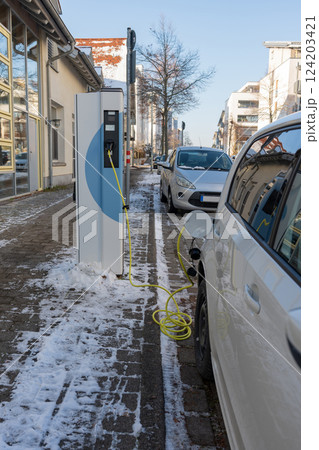 An electric car on the street is being charged in Germany. 124203421
