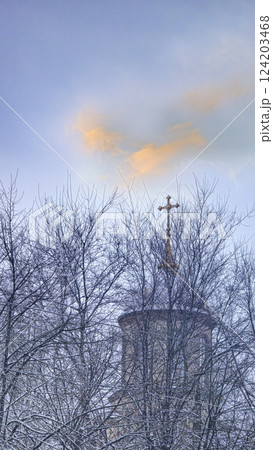 Blue sky with clouds, winter weather. Clouds on the background of trees. Blue sky with clouds, winter weather. Clouds on the background of trees. 124203468