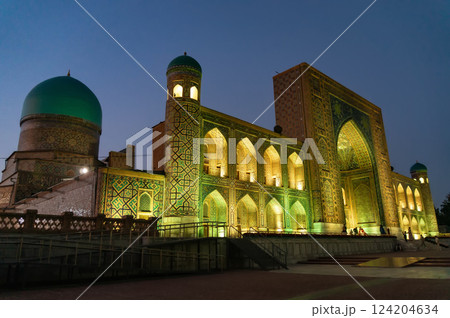 Tillya-Kari Madrasah on Registan Square with festive evening color lighting. Samarkand, Uzbekistan. 124204634