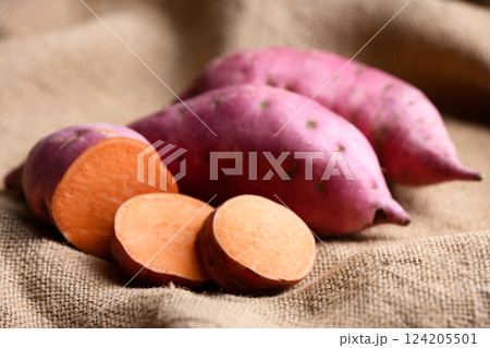 Close up of pink organic sweet potatoes with orange flesh 124205501
