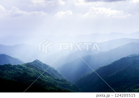 Picturesque blue mountain ranges glowing by sun rays 124205515