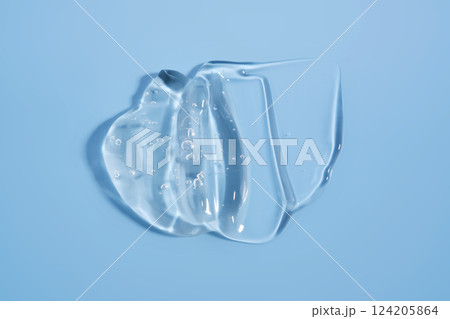 The texture of a cosmetic gel on a blue background. 124205864