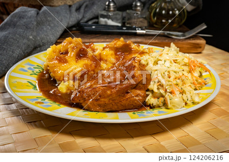 Braised pork ribs with spicy sauce served with mashed potatoes and salad. 124206216