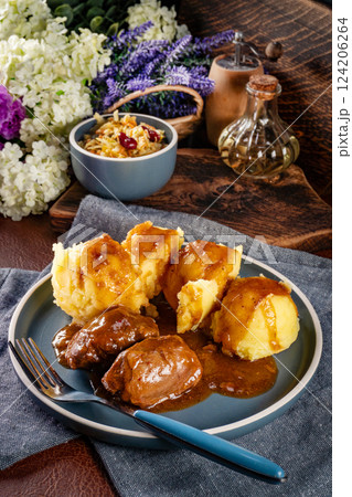 Traditional German braised pork cheeks in brown sauce. 124206264
