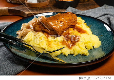 Braised pork ribs with spicy sauce served with mashed potatoes and sauerkraut. 124206578
