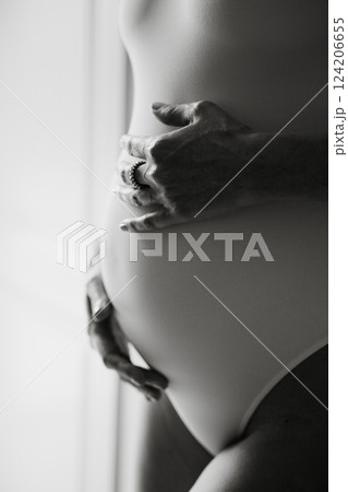 Expectant Mother Embracing Pregnancy with Hand Touch 124206655