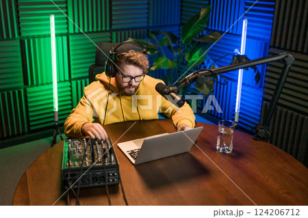 Handsome man radio DJ hosting a radio show, entertainment and communication concept Handsome man radio DJ hosting a radio show, entertainment and communication concept 124206712