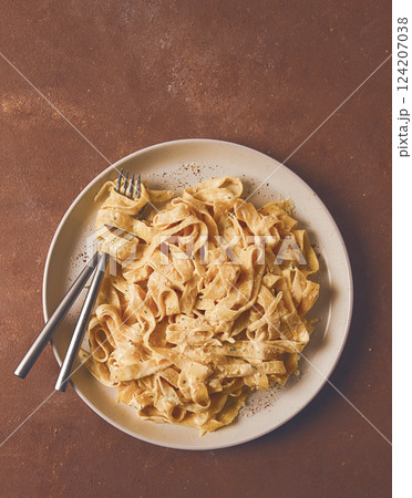 Fettuccine, tagliatelle, in creamy garlic sauce, Italian traditional cuisine, pasta carbonaro, 124207038