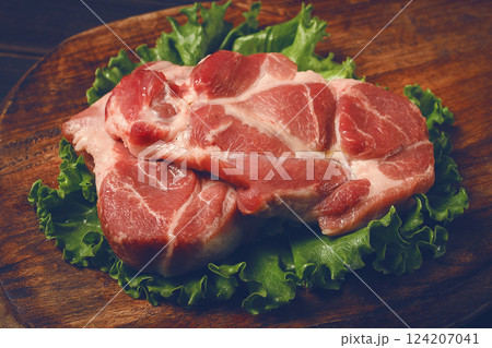 raw pork steak, two pieces, on a wooden background, raw pork steak, two pieces, on a wooden background, 124207041