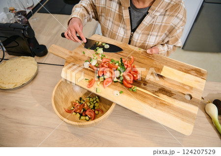 Preparing Fresh Vegetable Salad in a Cozy Home Kitchen Preparing Fresh Vegetable Salad in a Cozy Home Kitchen 124207529