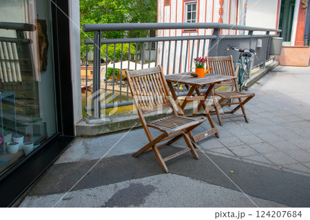 Cafe on the open air. Chairs and tables outside on the summer sun weather in Germany near the river. Design of furnitureset for summer cafe or restaurant. 124207684
