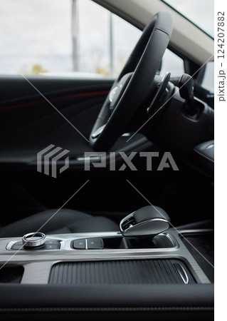 Selector automatic transmission with leather in the interior of a modern expensive car. The background is blurred. Black and brown leather car. 124207882