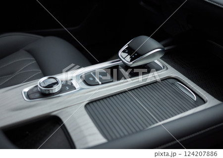 Selector automatic transmission with leather in the interior of a modern expensive car. The background is blurred. Black and brown leather car. 124207886