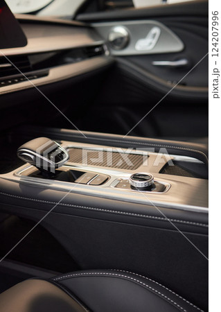 Selector automatic transmission with leather in the interior of a modern expensive car. The background is blurred. Black and brown leather car. 124207996