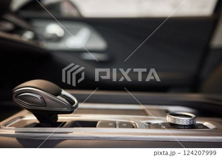 Selector automatic transmission with leather in the interior of a modern expensive car. The background is blurred. Black and brown leather car. 124207999