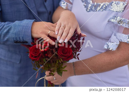 Close-up photo of the men s holding woman hand with golden wedding ring with diamond. Wedding ring before the proposal. Luxury wedding rings Close-up photo of the men s holding woman hand with golden wedding ring with diamond. Wedding ring before the proposal. Luxury wedding rings 124208017