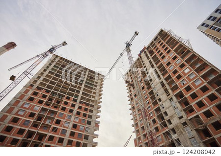 It is view of a new incomplete house without tiles on roof in sunny summer day. It is a close up view of modern house without roof. It is close up view of unfinished building apartment It is view of a new incomplete house without tiles on roof in sunny summer day. It is a close up view of modern house without roof. It is close up view of unfinished building apartment 124208042