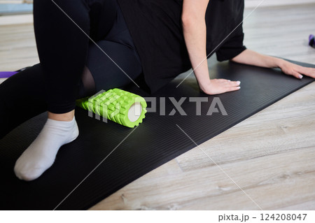 Myofascial release,Massaging fascia calf muscles with myofascial roll,fitness,self-care,health,smart fitness.Myofascial relaxationmuscles foot with a massage ball mat at home,smart fitness,mfr 124208047