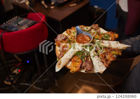 Assorted kebabs on board with red onion Assorted kebabs on board with red onion 124208060