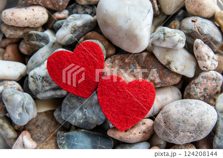 Two red hearts made of material fabric on the black background. Concept of Valentine's day and romantic love. 124208144