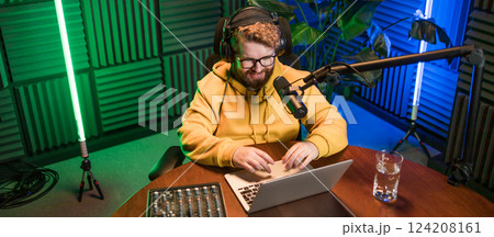 Banner Live streaming with smiling millennial man as radio presenter with microphone, talk show or entertainment. Male person content creator and happy on podcast host in studio for recording audio or 124208161