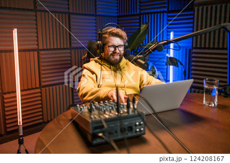 Handsome man radio DJ hosting a radio show, entertainment and communication concept 124208167