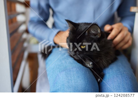 young man holding and petting cute cat male young man holding and petting cute cat male 124208577