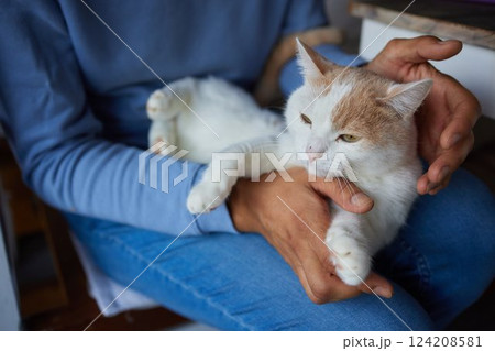 young man holding and petting cute cat male 124208581