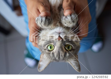 young man holding and petting cute cat male 124208592