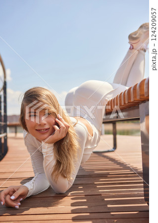 Portrait of fit and sporty young woman doing stretching in city. Portrait of fit and sporty young woman doing stretching in city. 124209057