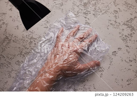 hand in a vacuum bag. hair dryer to get rid of air 124209263
