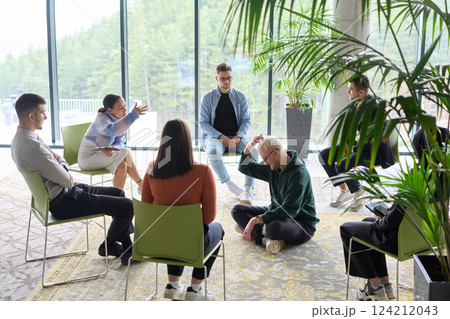 Corporate business team meeting with a manager or coach. Group of happy diverse, multiracial people sitting in a circle Corporate business team meeting with a manager or coach. Group of happy diverse, multiracial people sitting in a circle 124212043