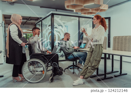 Young group of business people brainstorming together in a startup space, discussing business projects, investments, and solving challenges. 124212146