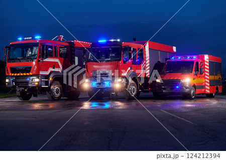 A pair of highly modern and quality fire trucks illuminate the night with their rotating lights, symbolizing the cutting-edge technology and preparedness of the firefighting fleet, ready to respond to A pair of highly modern and quality fire trucks illuminate the night with their rotating lights, symbolizing the cutting-edge technology and preparedness of the firefighting fleet, ready to respond to 124212394
