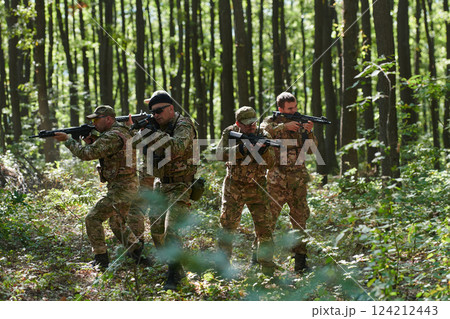A specialized military antiterrorist unit conducts a covert operation in dense, hazardous woodland, demonstrating precision, discipline, and strategic readiness 124212443