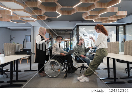 Young group of business people brainstorming together in a startup space, discussing business projects, investments, and solving challenges. 124212592