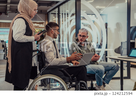 Young group of business people brainstorming together in a startup space, discussing business projects, investments, and solving challenges. Young group of business people brainstorming together in a startup space, discussing business projects, investments, and solving challenges. 124212594