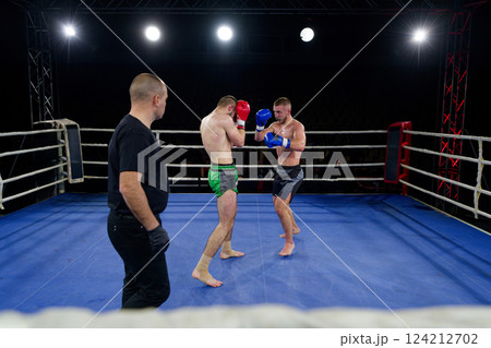 Kickboxing rivals unleash powerful leg strikes in a thrilling match. 124212702