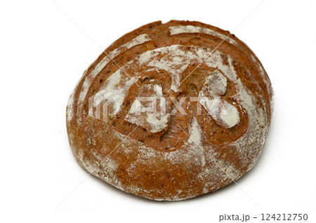 Freshly baked artisanal bread with unique design resting on clean surface 124212750