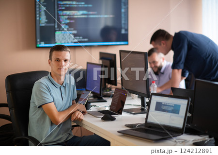 Innovating the Future: A Young Programmer Testing New Smartphone Apps in the Office. 124212891