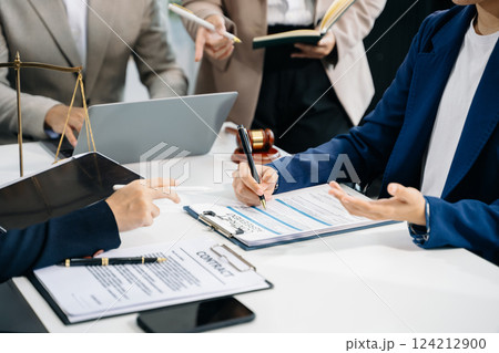 business people and lawyers discussing contract papers sitting at the table. Concepts of law 124212900