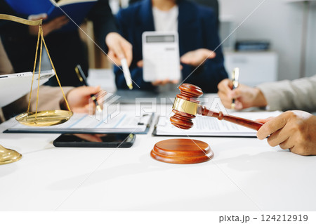 business people and lawyers discussing contract papers sitting at the table. Concepts of law, advice, legal services. business people and lawyers discussing contract papers sitting at the table. Concepts of law, advice, legal services. 124212919