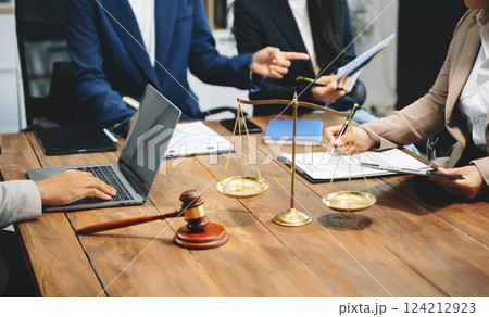business people and lawyers discussing contract papers sitting at the table. Concepts of law, advice, legal services. 124212923