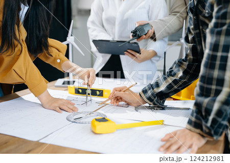 Creative architect projecting on the big drawings with architectural project at construction site Creative architect projecting on the big drawings with architectural project at construction site 124212981