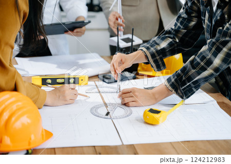 Creative architect projecting on the big drawings with architectural project at construction site 124212983