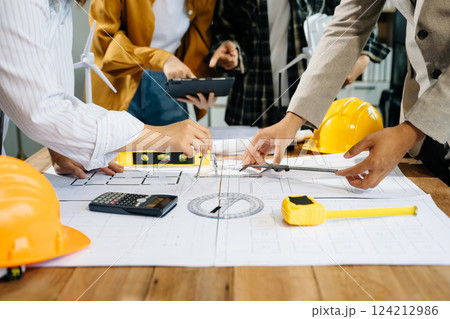Creative architect projecting on the big drawings with architectural project Creative architect projecting on the big drawings with architectural project 124212986