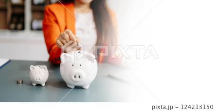 woman hand coins with piggy bank. business finance saving and investment concept. 124213150